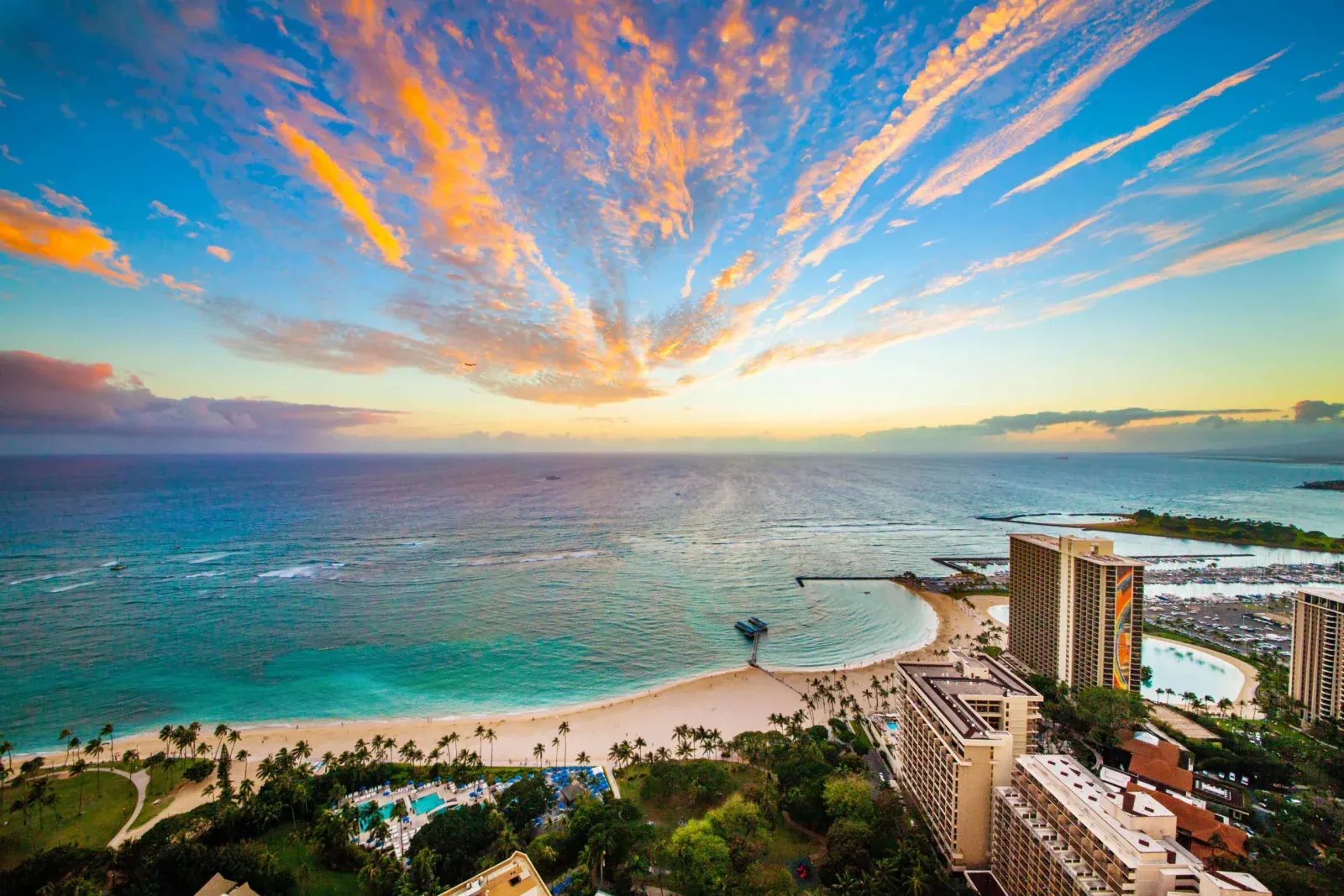 Sunset over the ocean and grounds of Hilton Hawaiian Village in Waikīkī