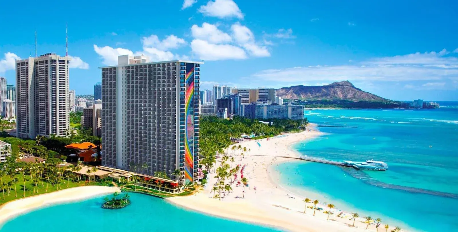Turquoise ocean, Waikīkī Beach, and Diamond Head beside Hilton Hawaiian Village